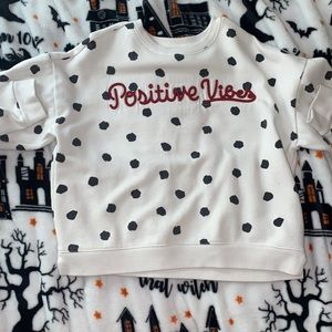 This is a black and white poka dot shirt with no holes, rips,or stains.